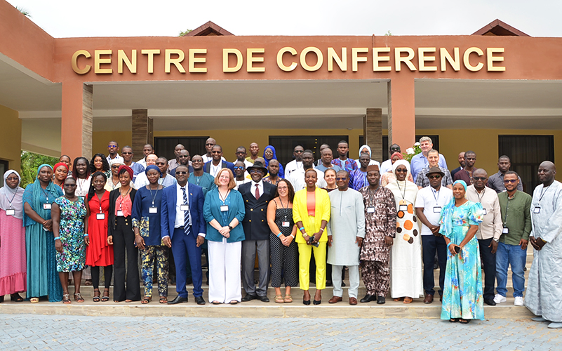 Photo of a group of participants at the COHWA meeting in front of a conference center.