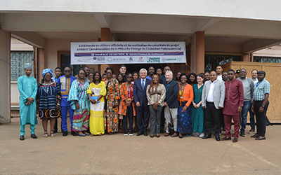 Group photo at the closing ceremony in Cameroon, in front of a building.