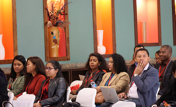 Participants at the closing ceremony of the APRECIT project. People are sitting on a chair.