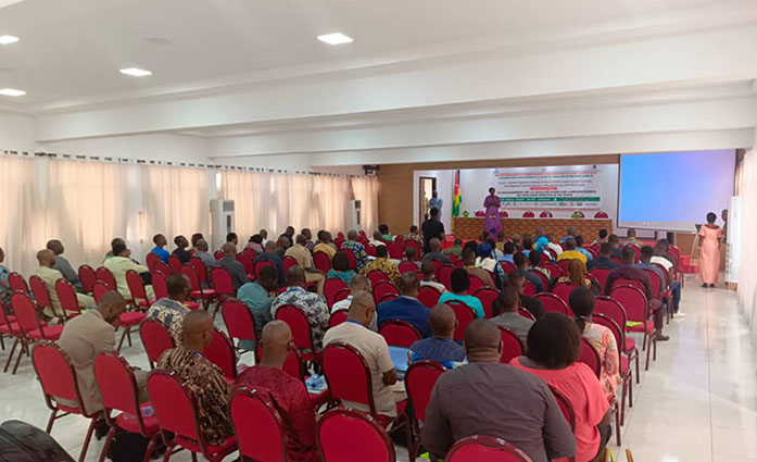 Participants, seated on a chair, attend a presentation.