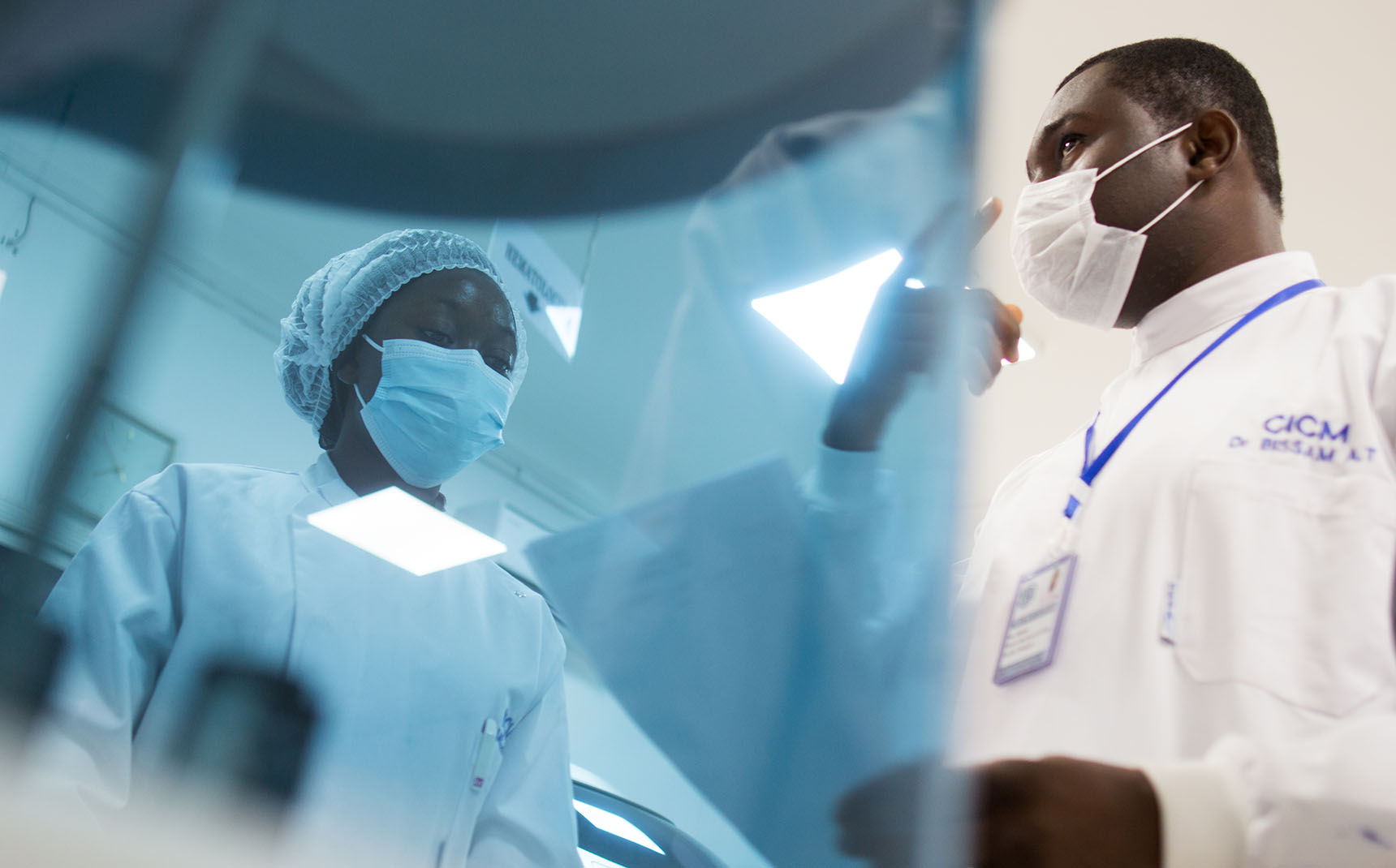 From a low angle, two health professionals are talking.