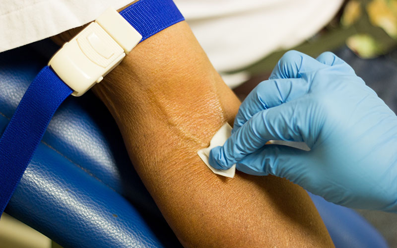 patient’s arm being disinfected before sampling in Myanmar