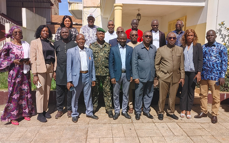 Outside a building, about ten people are standing.