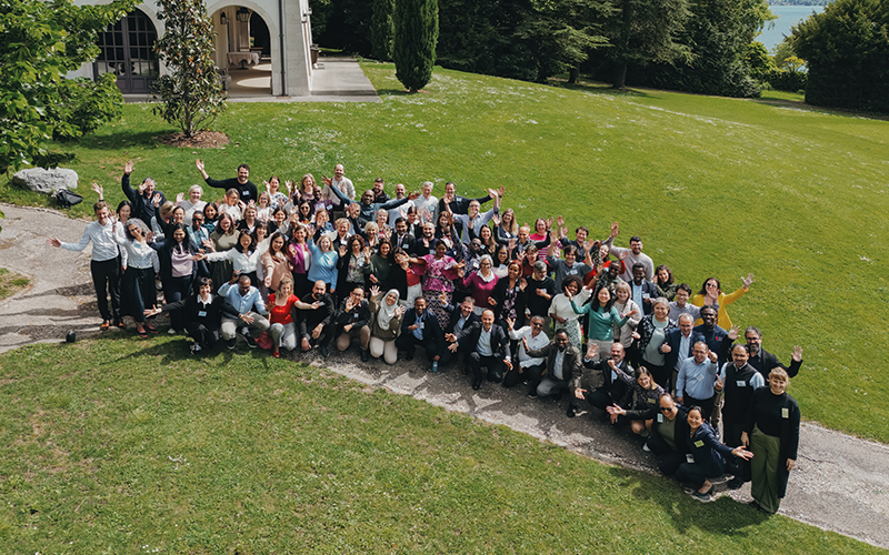 Group photo of the participants in a park with trees in the background